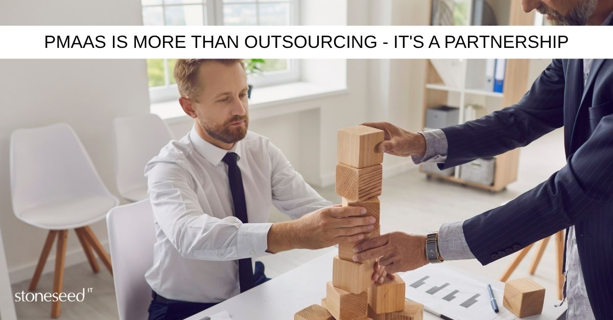 business people playing with building blocks