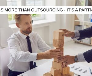 business people playing with building blocks